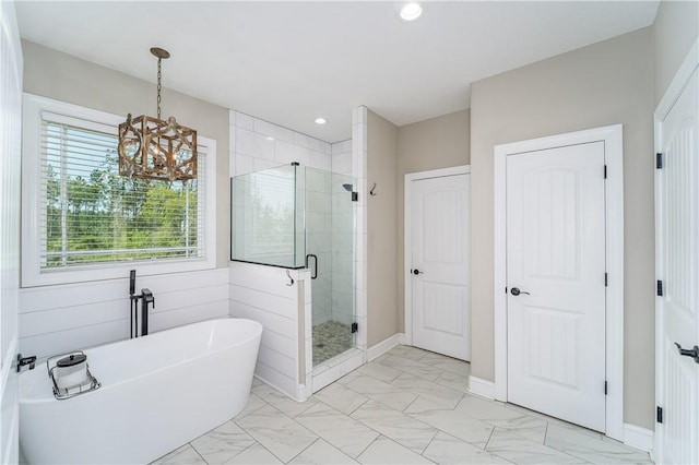 121 Farms Edge Rd S, Manor, GA 31550 - full bathroom with a freestanding bath, marble look tile flooring, a stall shower, a chandelier, and recessed lighting