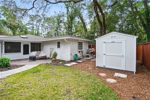 111 Palm Dr, Saint Simons Island, GA 31522 - rear view of property with a fenced backyard, a patio area, a sunroom, a shed, and stucco siding