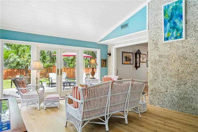 111 Palm Dr, Saint Simons Island, GA 31522 - living area featuring vaulted ceiling, wood finished floors, and french doors