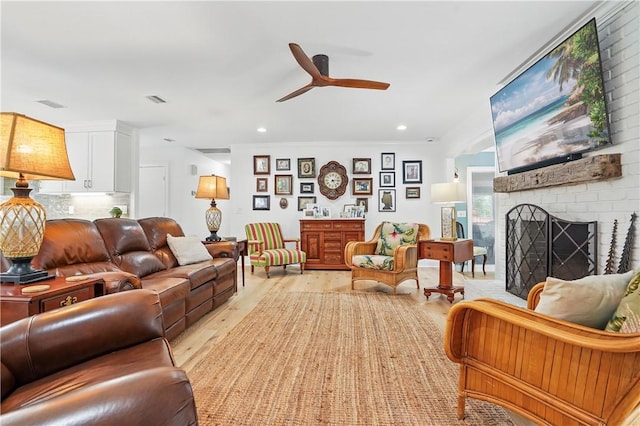 111 Palm Dr, Saint Simons Island, GA 31522 - living room with light wood finished floors, a ceiling fan, recessed lighting, and a brick fireplace