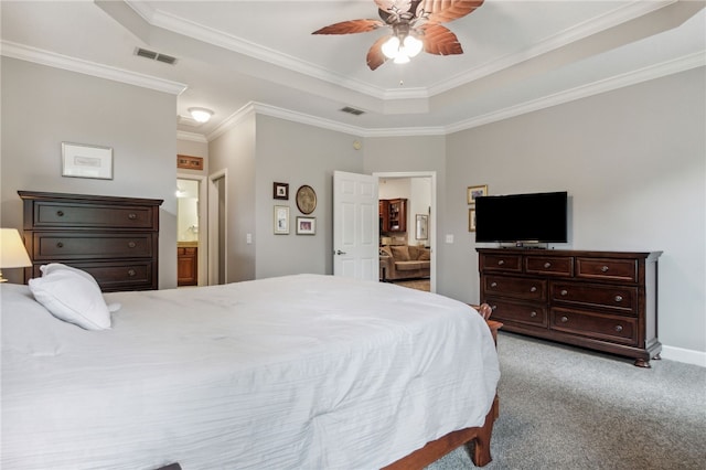 carpeted bedroom with ensuite bathroom, a raised ceiling, ceiling fan, and crown molding