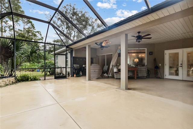 view of patio featuring french doors, glass enclosure, and ceiling fan