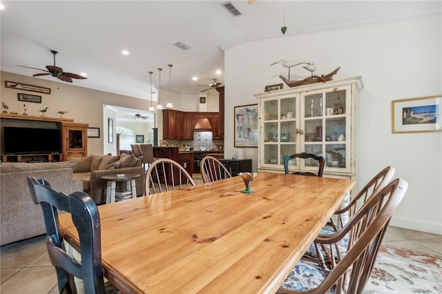 tiled dining space featuring crown molding