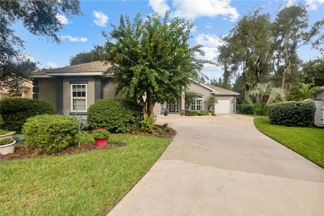 view of front of house with a front yard and a garage