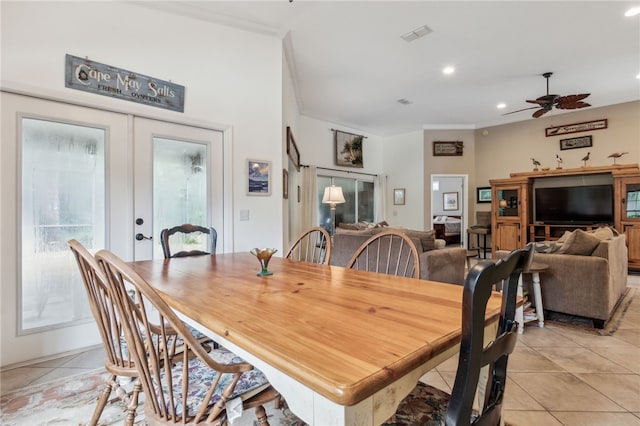 dining area with ceiling fan, light tile patterned floors, crown molding, and french doors