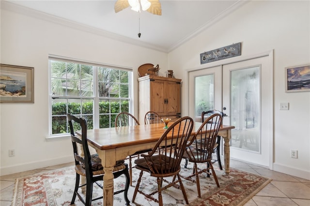 tiled dining room with french doors, crown molding, ceiling fan, and lofted ceiling