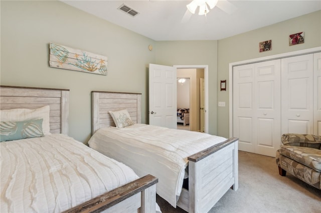 carpeted bedroom featuring ceiling fan and a closet