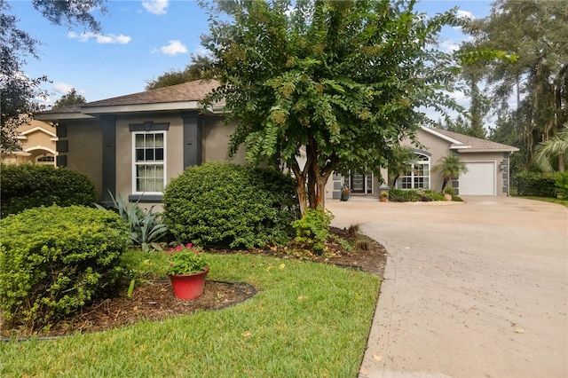 view of front of property with a front yard and a garage