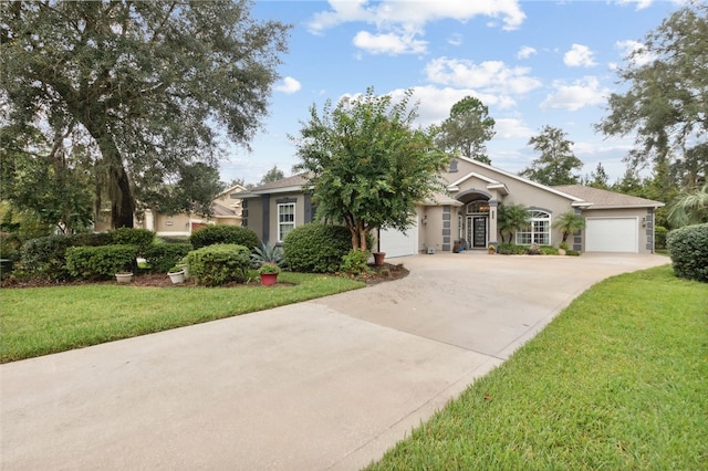 view of front of home featuring a garage and a front lawn