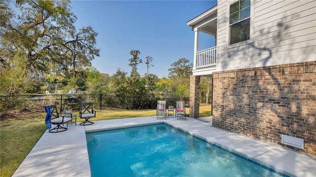 view of swimming pool with a lawn, a patio area, fence, and a fenced in pool