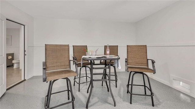 dining space with visible vents and speckled floor