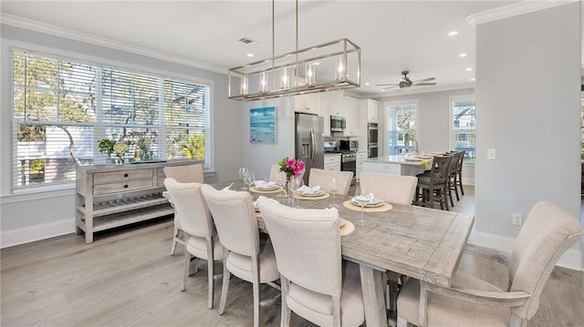 dining area with baseboards, ornamental molding, recessed lighting, and light wood-style floors