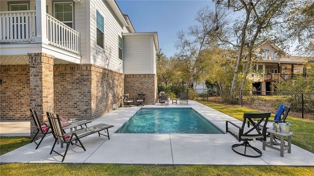 view of pool featuring a patio area, fence, and a fenced in pool