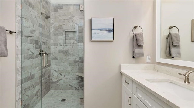 bathroom featuring a stall shower and vanity