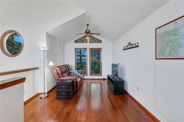 sitting room featuring ceiling fan, dark wood-type flooring, and vaulted ceiling