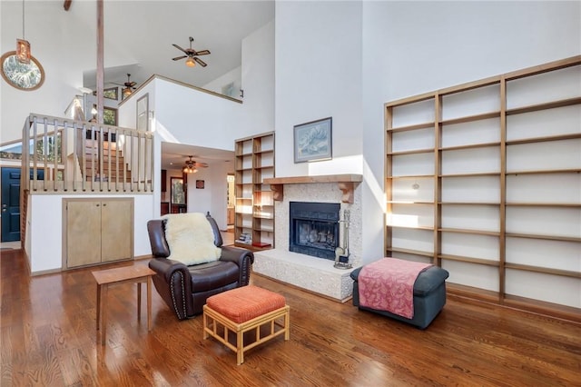 living room featuring high vaulted ceiling and wood-type flooring