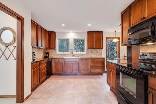 kitchen with black appliances, decorative light fixtures, sink, and tasteful backsplash