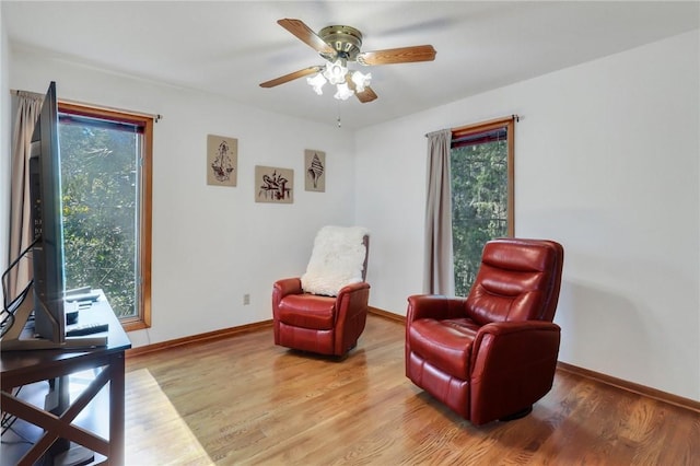 living area featuring ceiling fan and light wood-type flooring