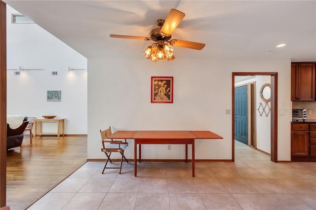 dining room with light wood-type flooring and ceiling fan