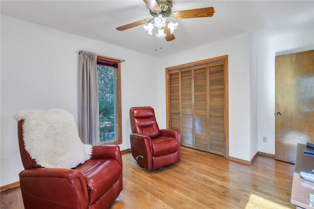 sitting room with ceiling fan and light hardwood / wood-style flooring