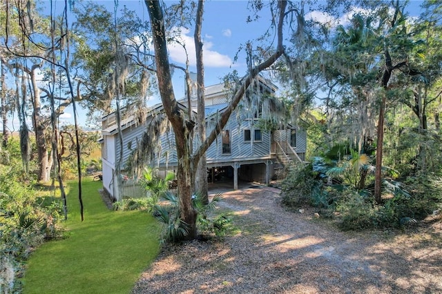 view of home's exterior with a yard and a carport