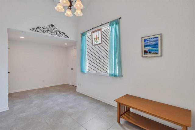 unfurnished room with a notable chandelier