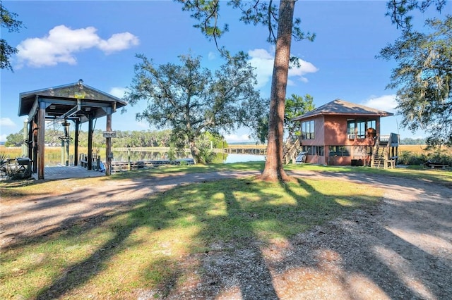 view of yard featuring a dock and a water view