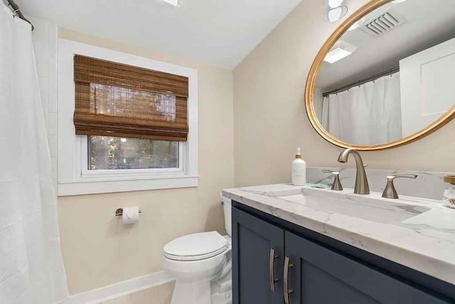 bathroom featuring tile patterned floors, vanity, and toilet