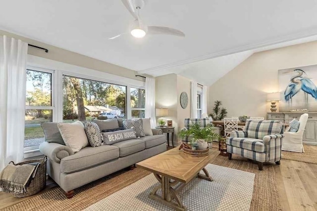 living room featuring ceiling fan, light hardwood / wood-style flooring, and lofted ceiling