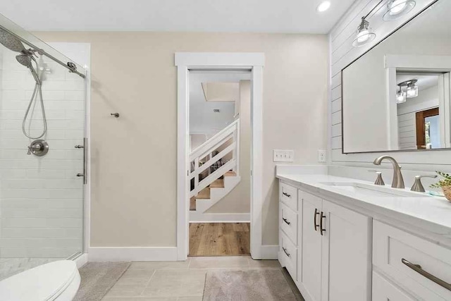 bathroom with tile patterned flooring, vanity, toilet, and an enclosed shower