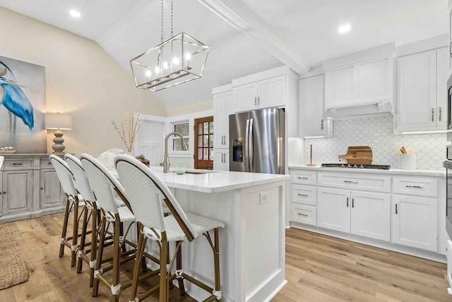 kitchen with white cabinetry, sink, an island with sink, and stainless steel appliances