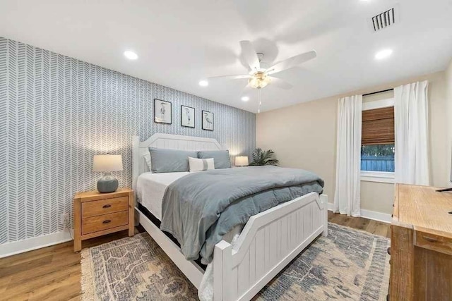 bedroom featuring hardwood / wood-style flooring and ceiling fan