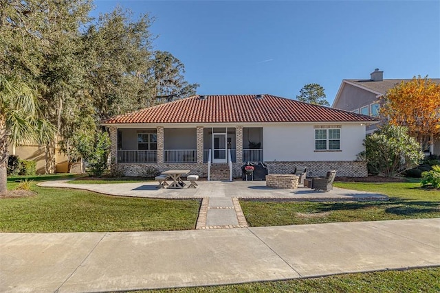 view of front of property with a front lawn and a patio