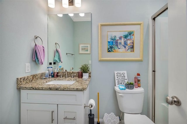 bathroom featuring vanity and toilet