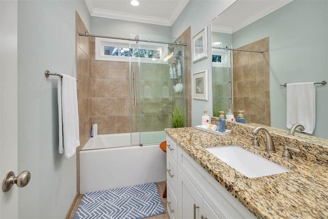 bathroom with vanity, bath / shower combo with glass door, and crown molding