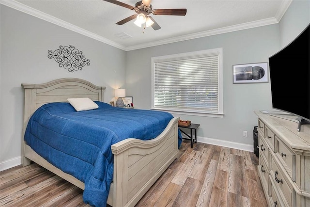 bedroom with hardwood / wood-style floors, ceiling fan, and ornamental molding