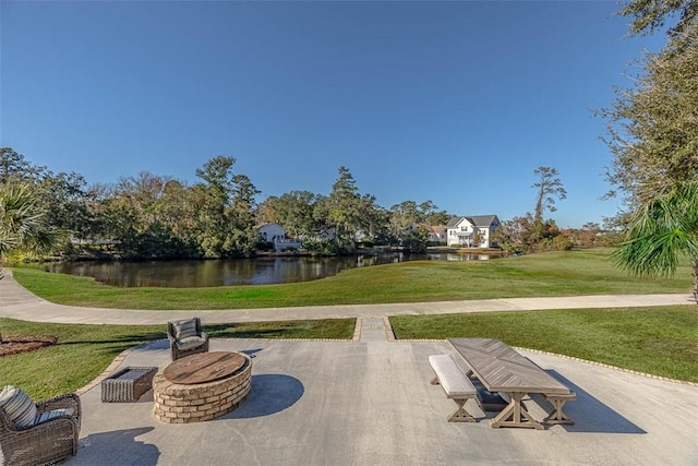 surrounding community with a patio area, a water view, and a yard