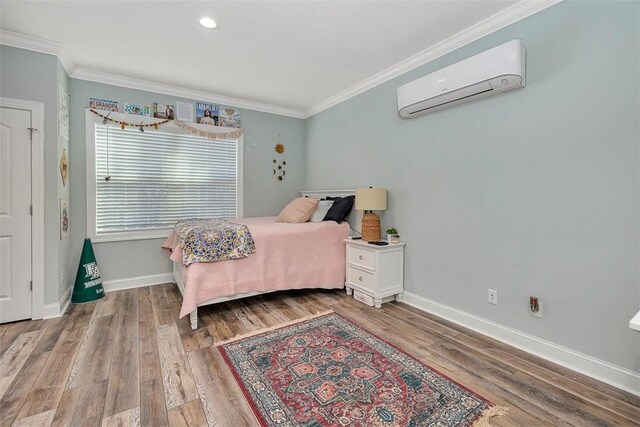 bedroom featuring hardwood / wood-style flooring, an AC wall unit, and crown molding