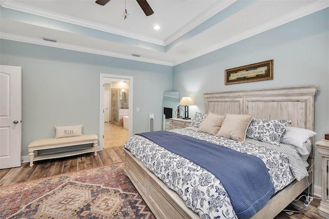 bedroom featuring ceiling fan, dark hardwood / wood-style floors, crown molding, and ensuite bath