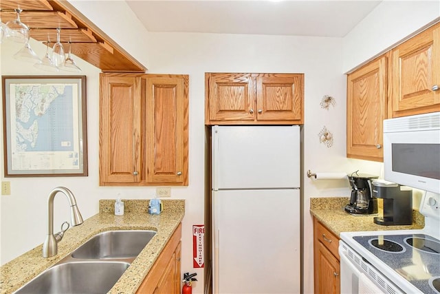 1524 Wood Ave Unit 314, Saint Simons Island, GA 31522 - kitchen featuring white appliances, a sink, and light stone counters