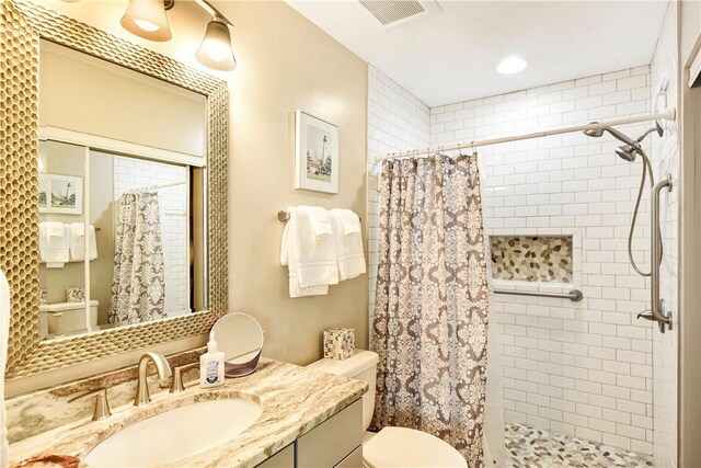 1524 Wood Ave Unit 314, Saint Simons Island, GA 31522 - full bathroom featuring toilet, vanity, and a tile shower