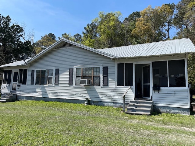 view of front of house with a front lawn, cooling unit, and a sunroom