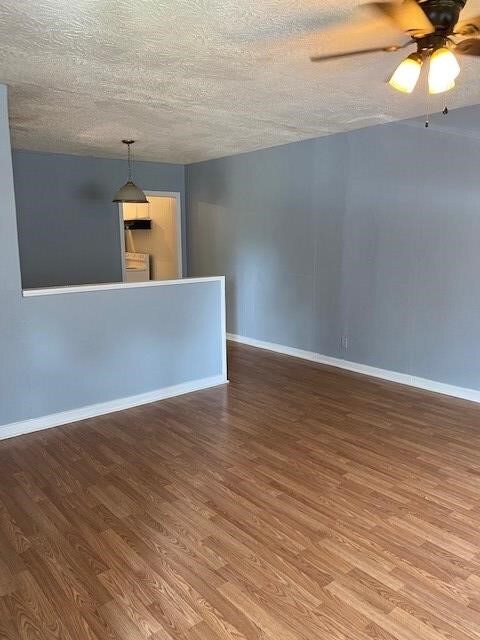 spare room featuring ceiling fan, a textured ceiling, and hardwood / wood-style flooring