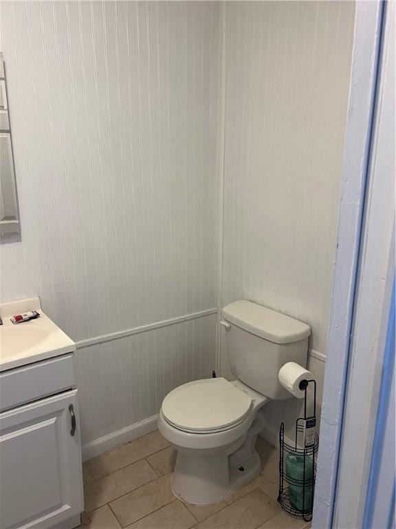 bathroom featuring tile patterned floors, vanity, and toilet