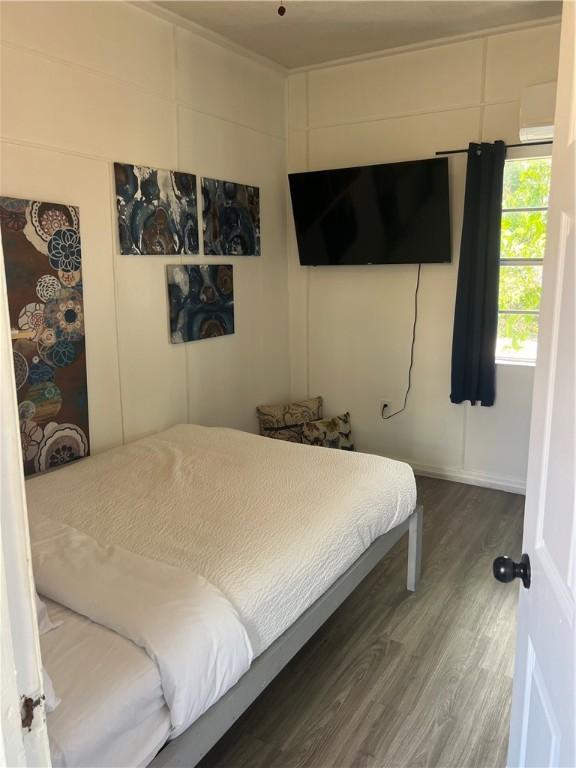 bedroom with wood-type flooring