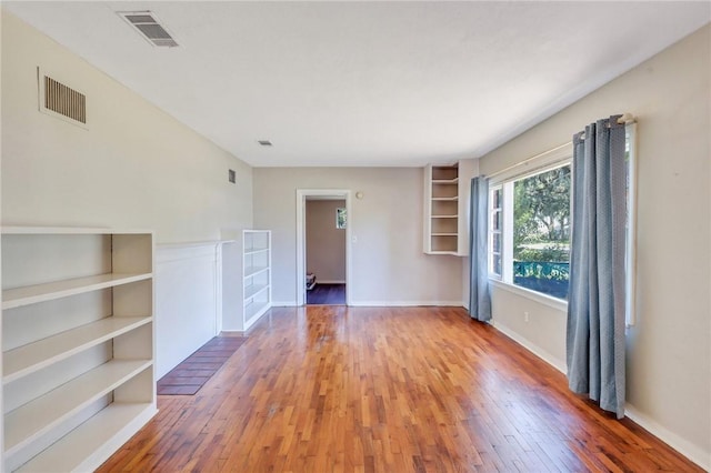 unfurnished room featuring hardwood / wood-style floors