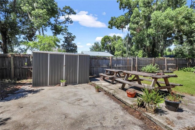 view of patio with a storage unit