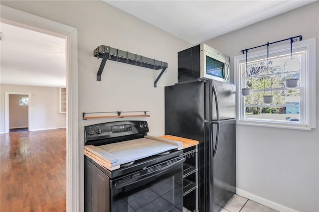 kitchen featuring black appliances and light wood-type flooring