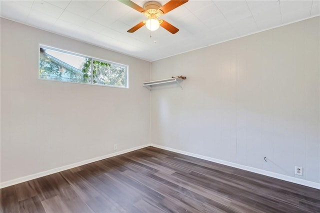 unfurnished room featuring ceiling fan and dark wood-type flooring