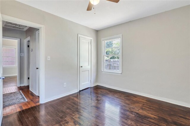 spare room with ceiling fan and dark hardwood / wood-style flooring